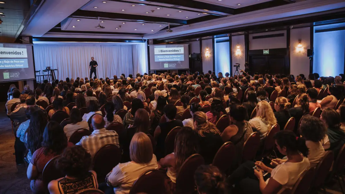 Salón de conferencias lleno de asistentes durante una charla de Federico Barolin
